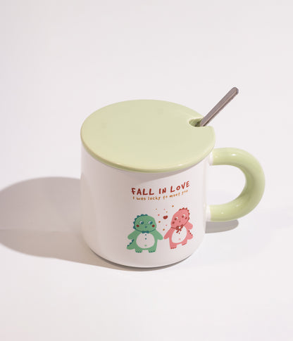 كوب قهوة سيراميك ابيض بتصميم ديناصور مرح مزود بغطاء اخضر وملعقة