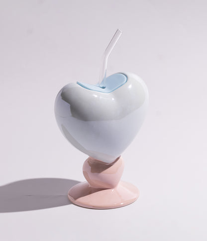 Vibrant heart-shaped ceramic mug with a straw for easy drinking